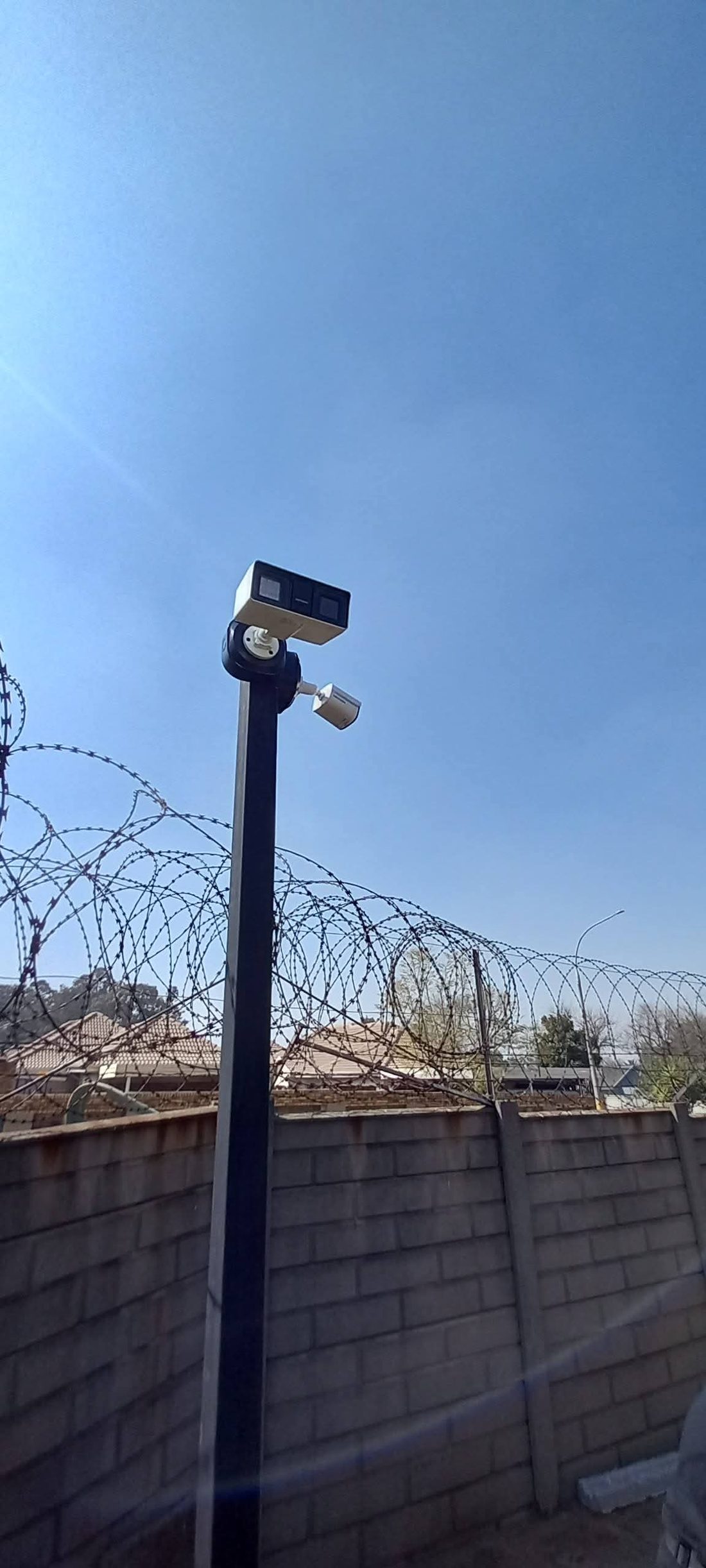 Perimeter cameras above razor wire